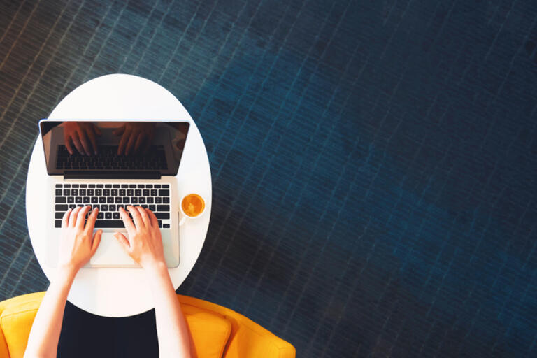 woman's hands on laptop keyboard