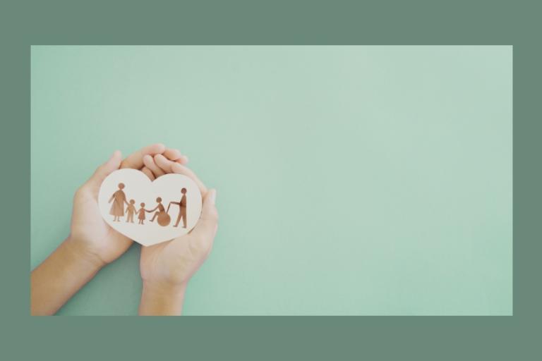 Two hands holding a heart shape plaque with several characters drawn on it