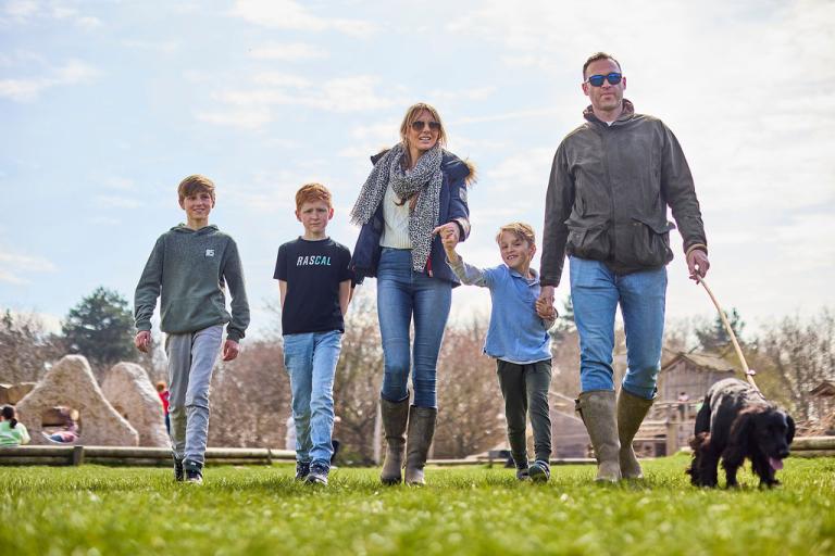 Family and dog on a walk through countryside