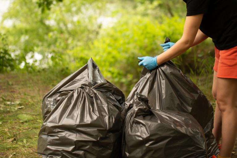 woman with black bin bags