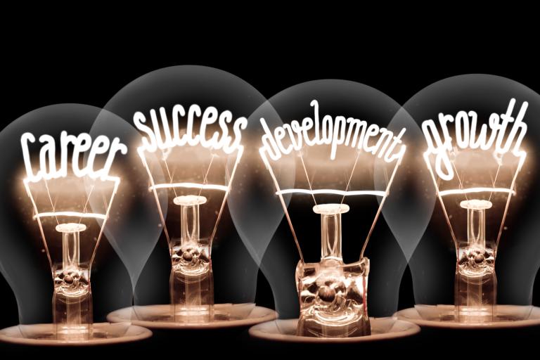 Four lightbulbs with the words career, growth