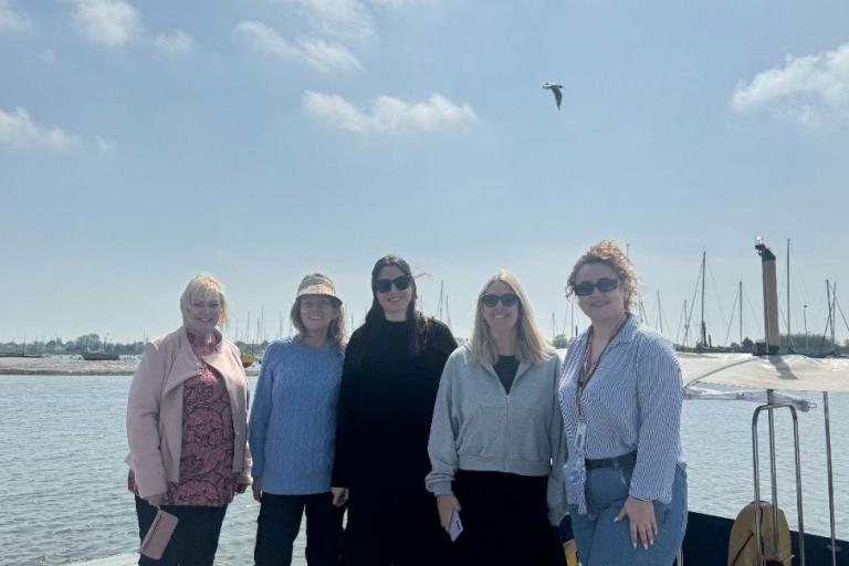 Pictured are members of the Visit Essex team together with a harbour behind them