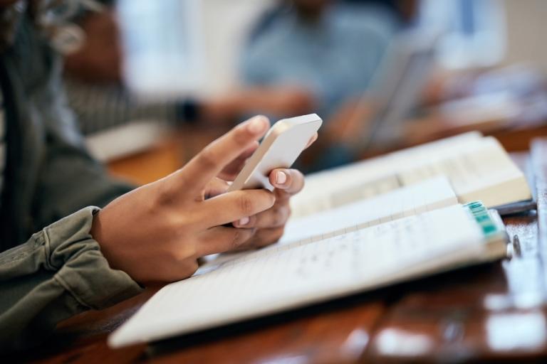 person's hand with a smartphone