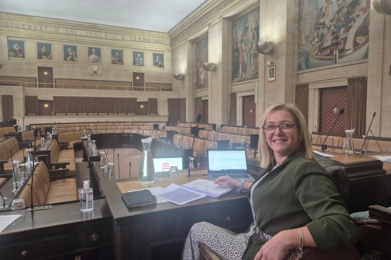 Nicole sitting at the front of the Council Chambers