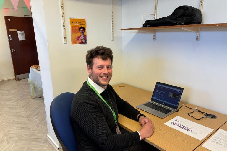Man sitting at a desk and smiling