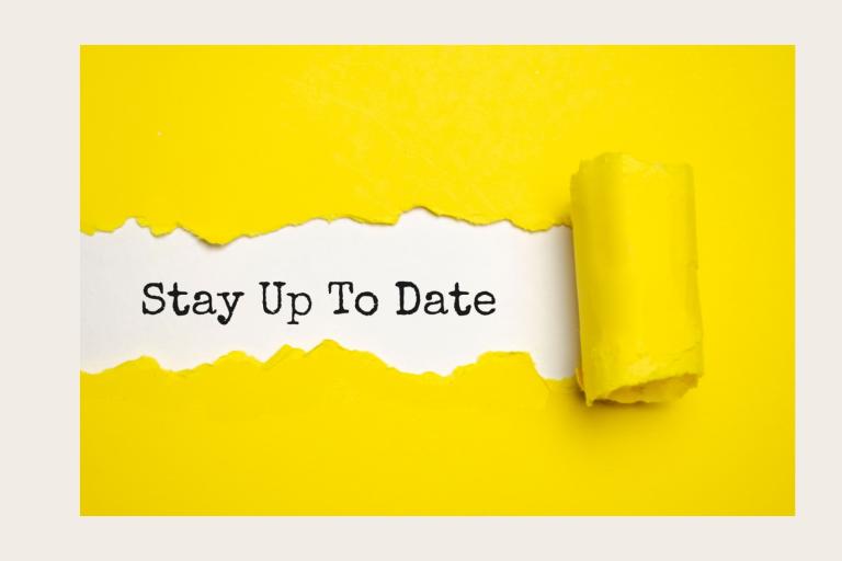 Yellow paper unpeeling to reveal the words stay up to date