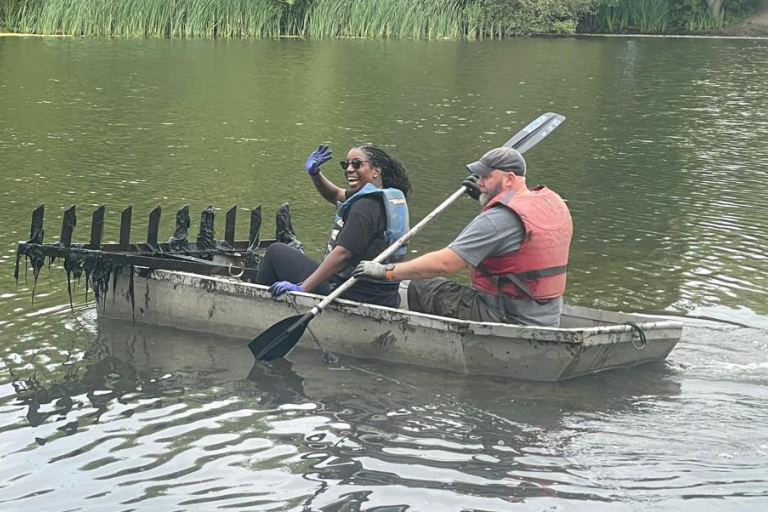 Picture of two people in a small boat on a lake, smiling
