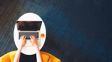 woman's hands on laptop keyboard