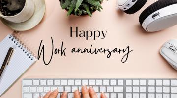 Work anniversary concept with keyboard and desk