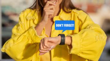 Woman in yellow top looking at her watch, with the words don't forget