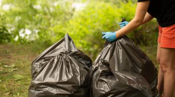 woman with black bin bags