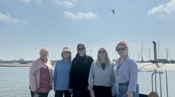 Pictured are members of the Visit Essex team together with a harbour behind them