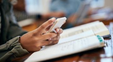 person's hand with a smartphone