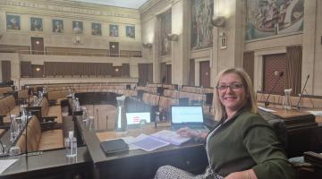 Nicole sitting at the front of the Council Chambers 
