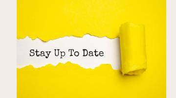 Yellow paper unpeeling to reveal the words stay up to date