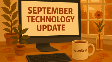 A realistic autumn-themed version of a workspace. A wooden desk with a computer monitor displaying technology update