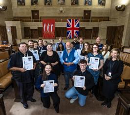 Group of colleagues holding their certificates