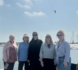 Pictured are members of the Visit Essex team together with a harbour behind them