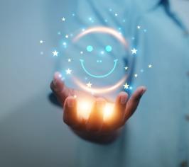 Picture of a hand held out, with a warm light coming from it and a smiley face icon above it