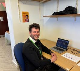 Man sitting at a desk and smiling