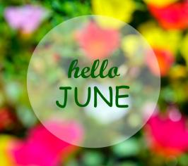 Words hello June in a circle, surrounded by a blurred out picture of colourful flowers
