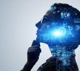 Woman wearing glasses, looking up and holding her chin. Projected over her face in blue are some circuit board and cog images